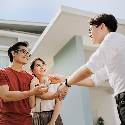 An asian chinese family moving into new house and received the house key from real estate agent